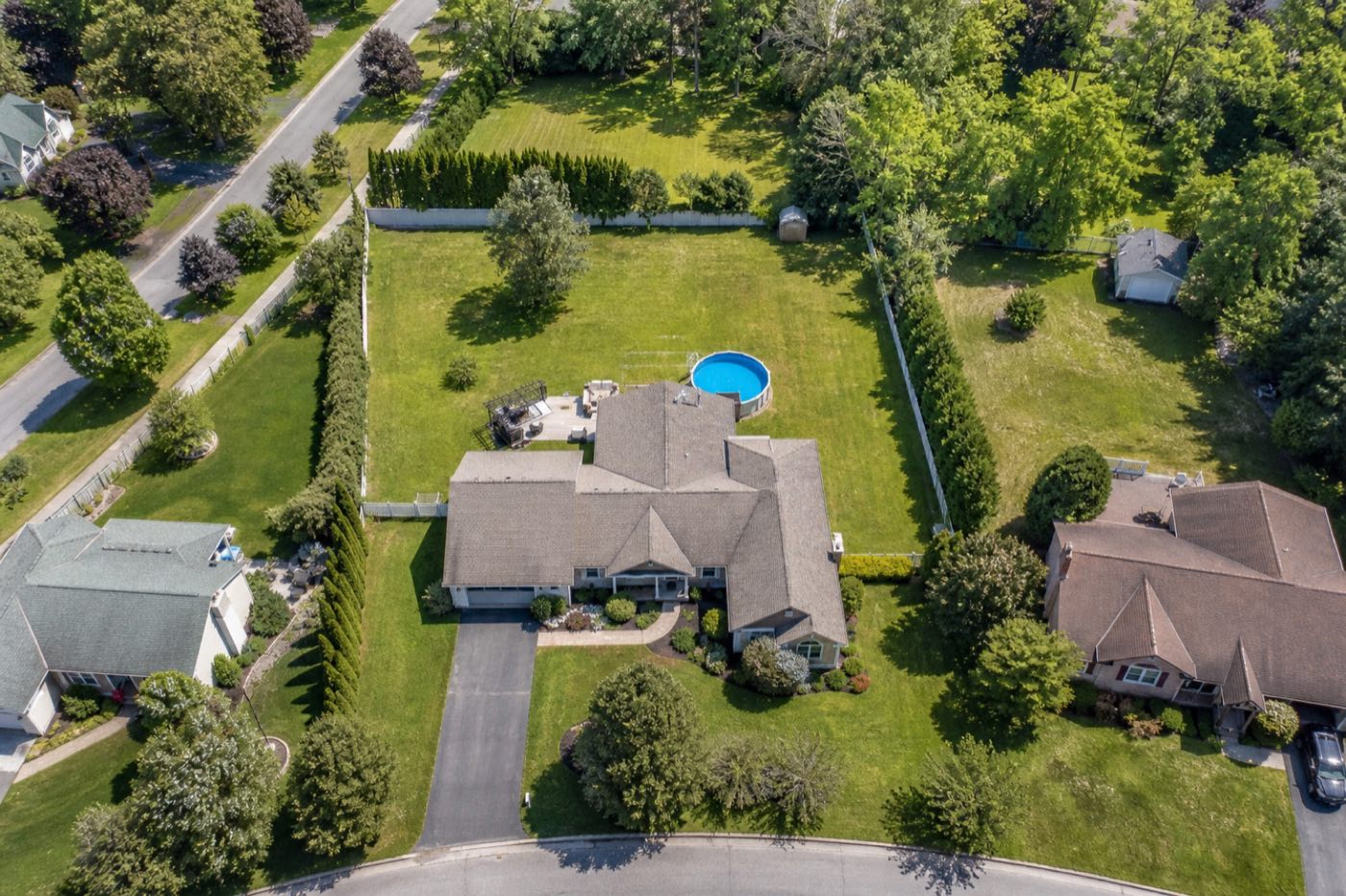 Aerial view of a single-family home with a large backyard lot ready for an ADU or duplex