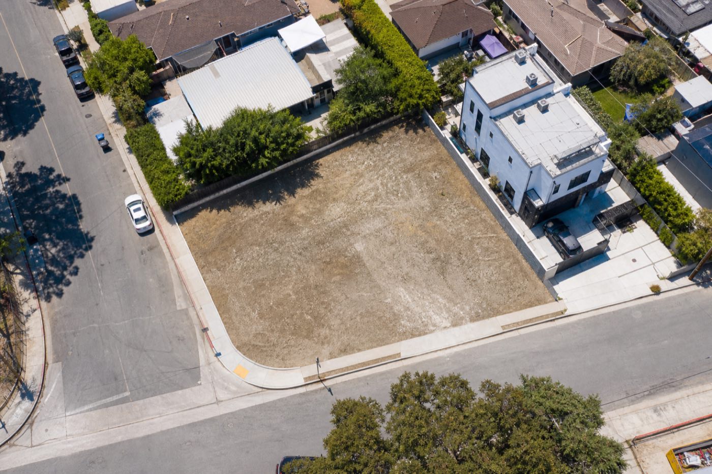 Aerial view of a vacant corner infill land parcel ready for development