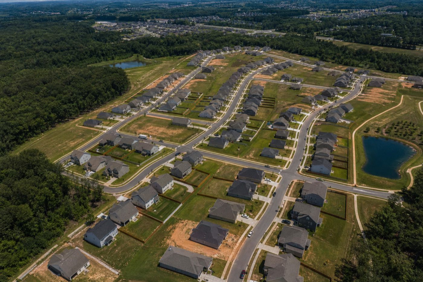 Aerial view of a residential subdivision with streets and homes on individual parcels